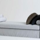 Белый диван-кровать с подушкой