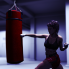 Спортивна дівчина з боксерським мішком боксу